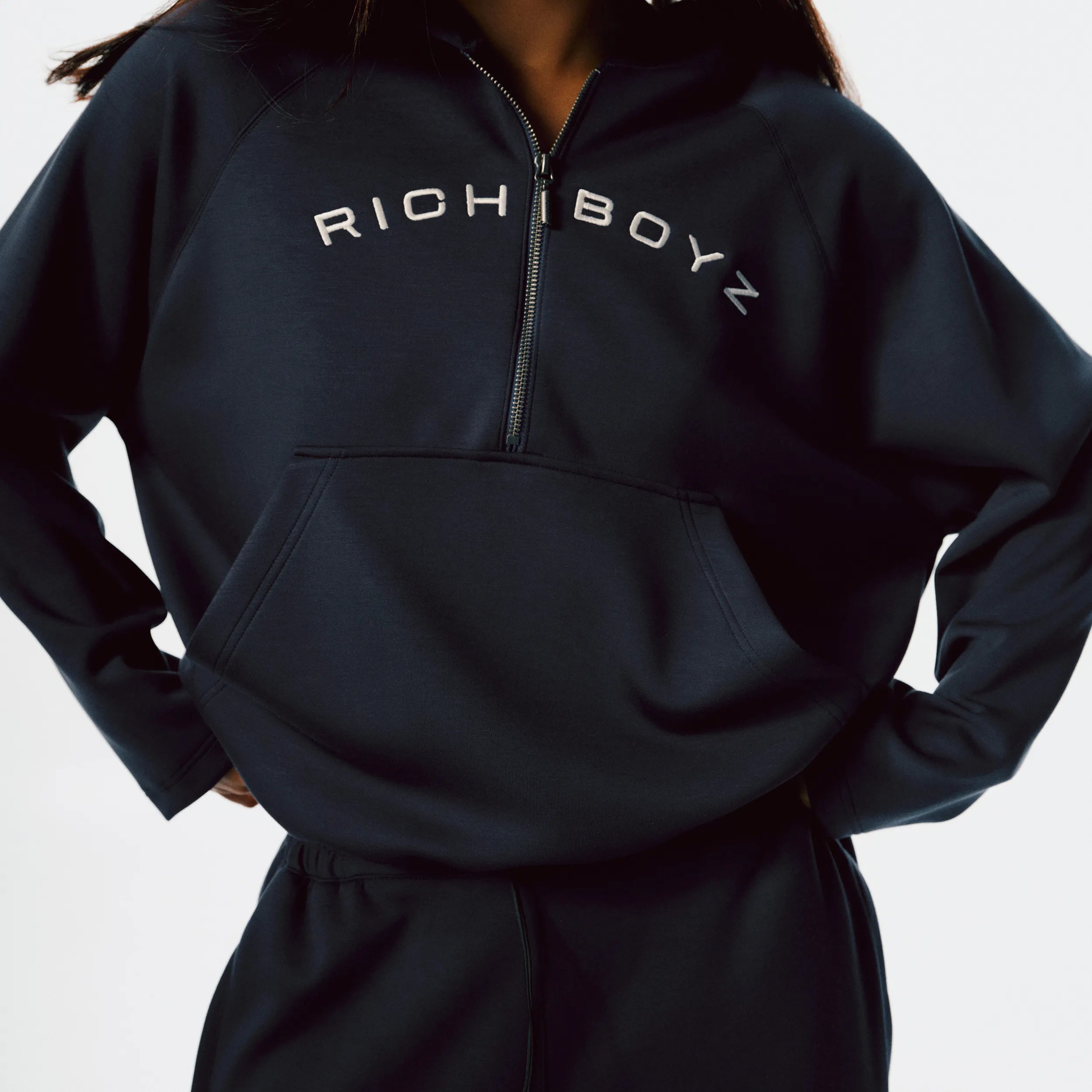 Close-up of Airy Quarter Zip Hoodie soft fabric texture and quarter-zip detail in Navy Blue