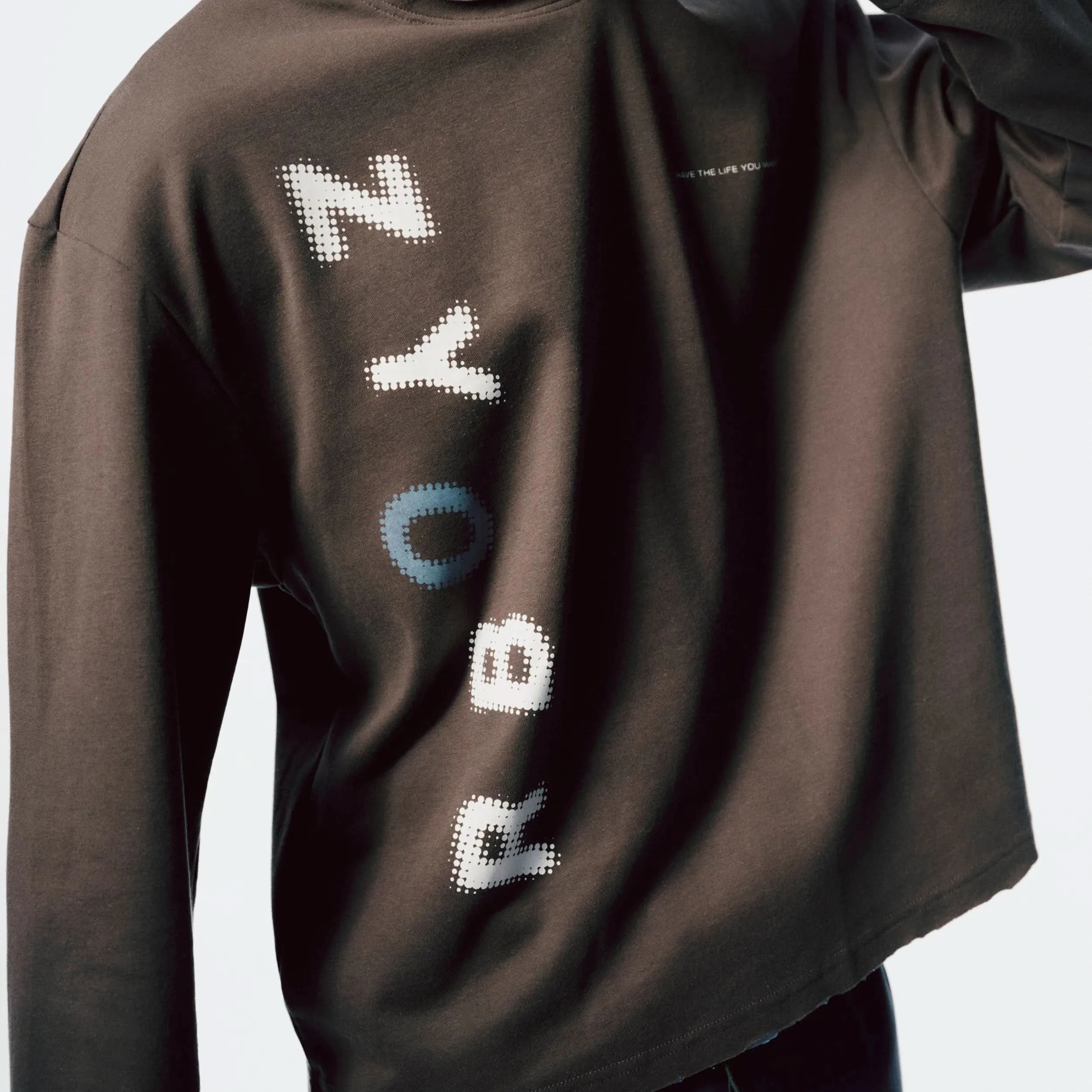 Close-up of Raw Edge Long Sleeve unfinished hem detail and soft fabric texture in Slate