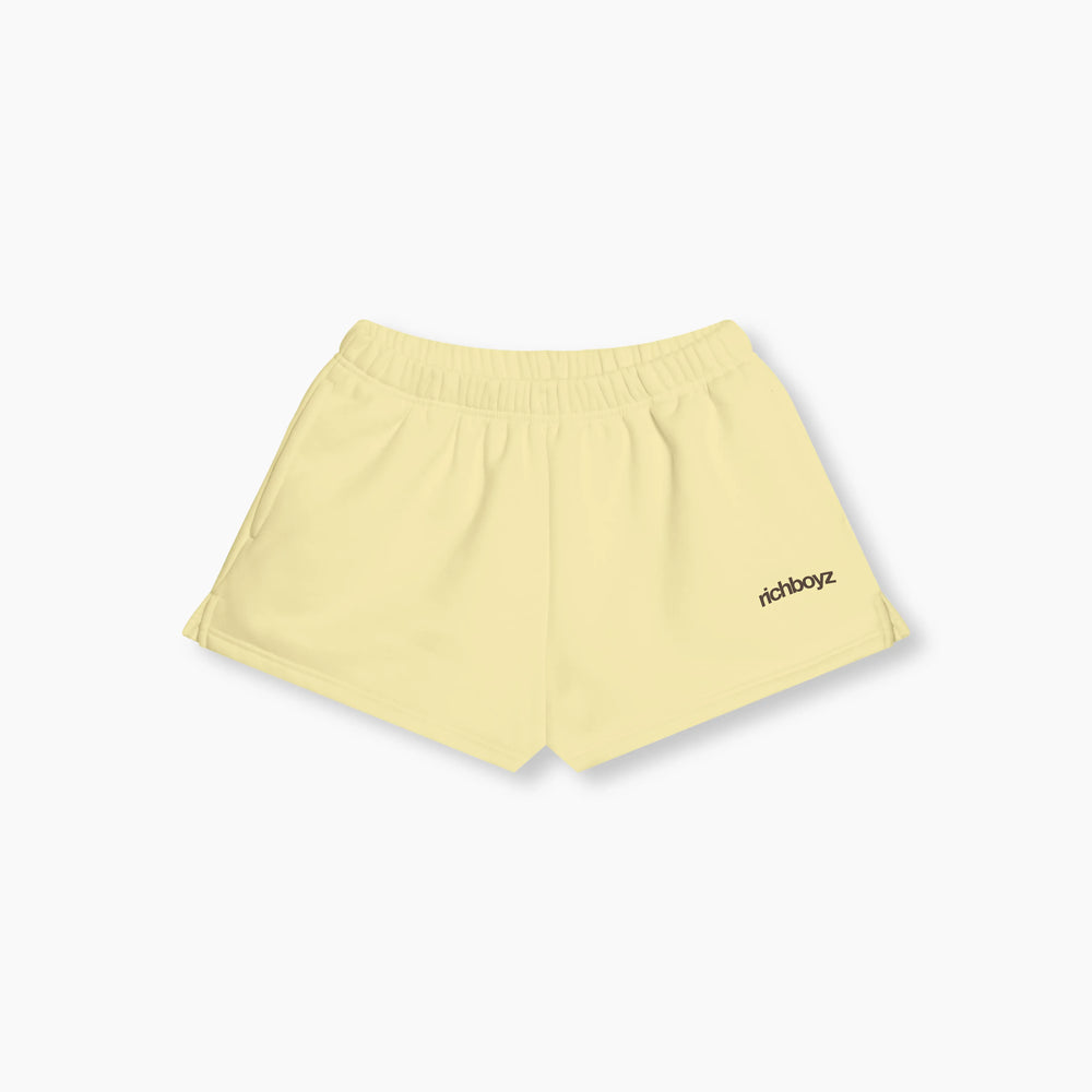 Light yellow shorts with 'rich boyz' logo on a white background