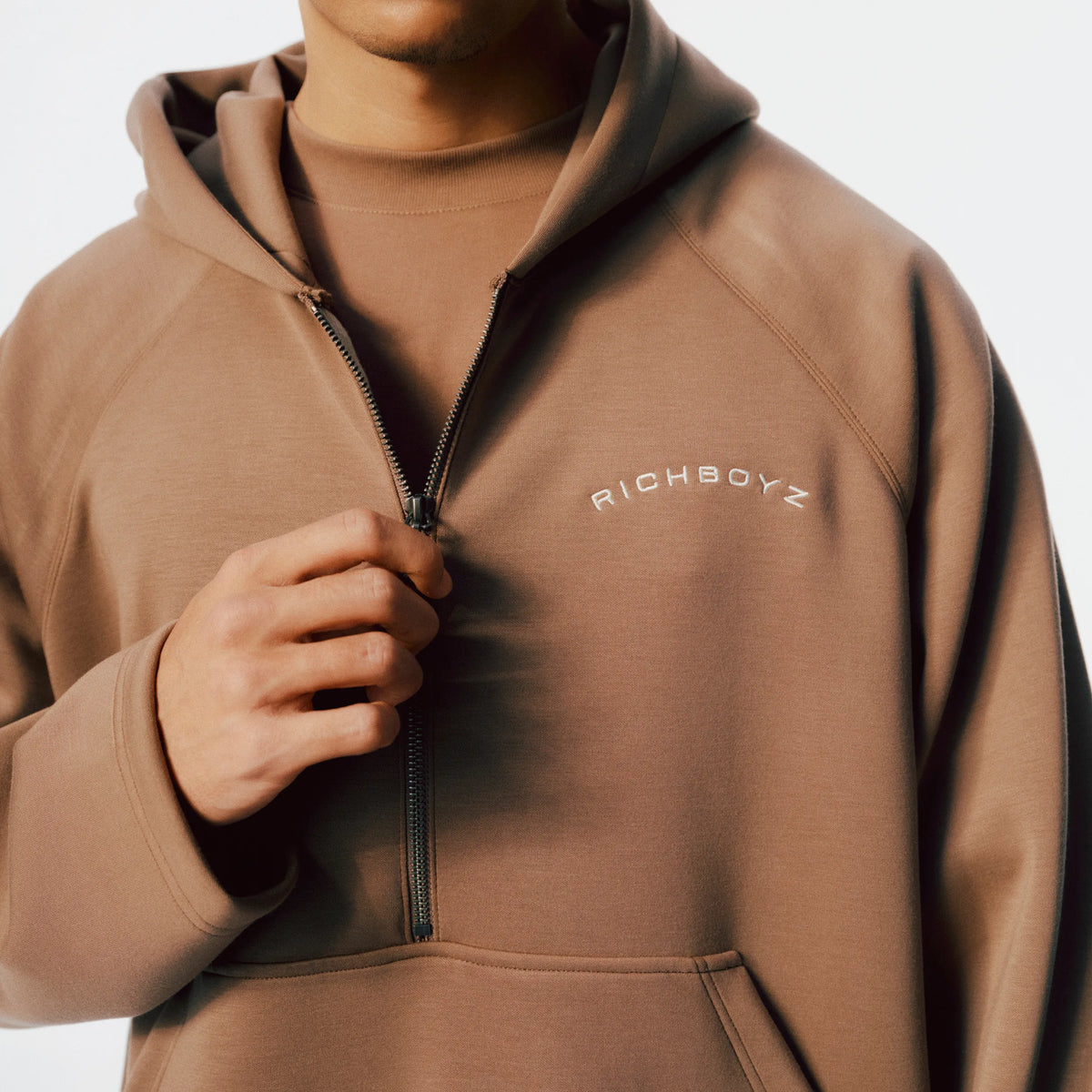 Close-up of Airy Quarter Zip Hoodie soft fabric texture and quarter-zip detail in Khaki