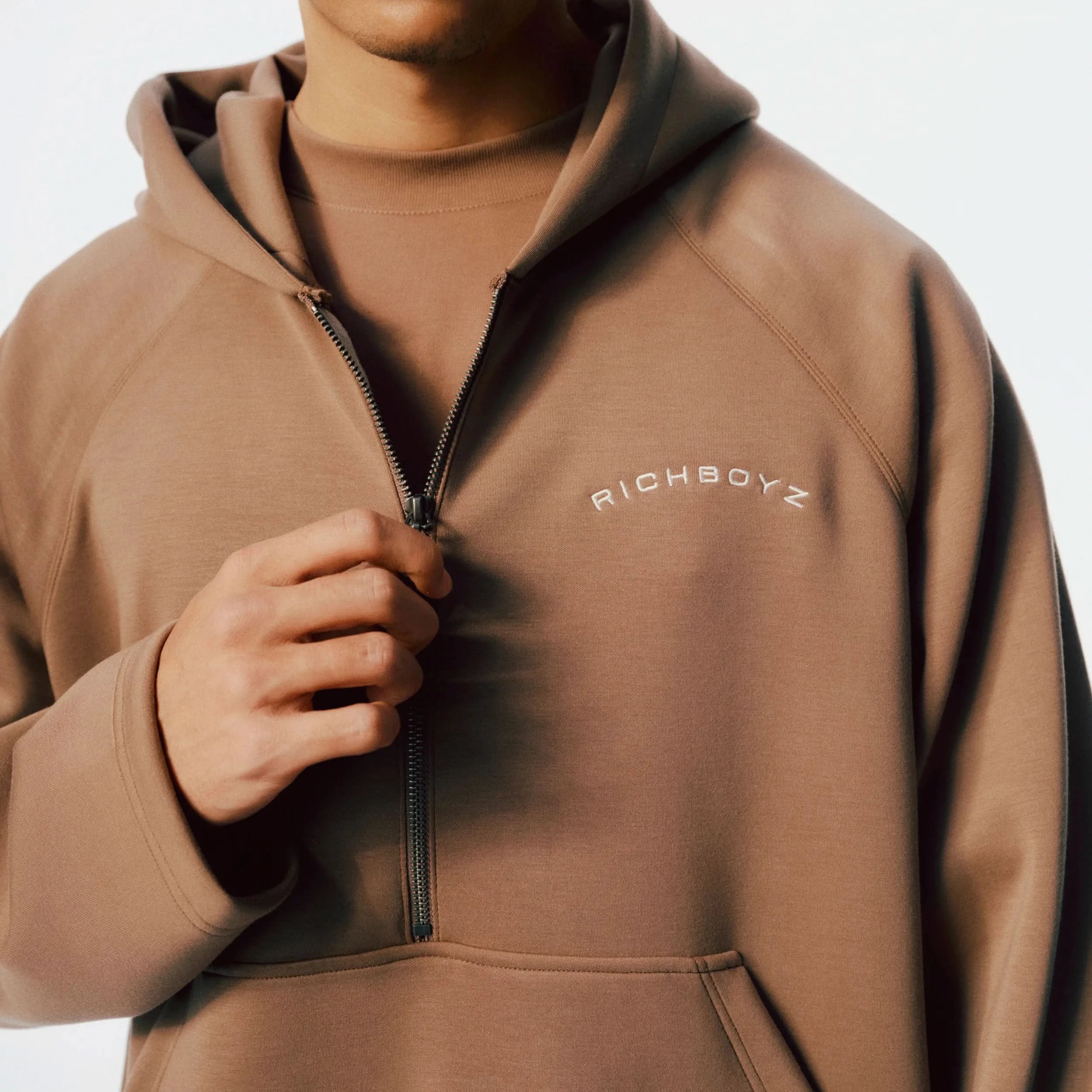 Close-up of Airy Quarter Zip Hoodie soft fabric texture and quarter-zip detail in Khaki