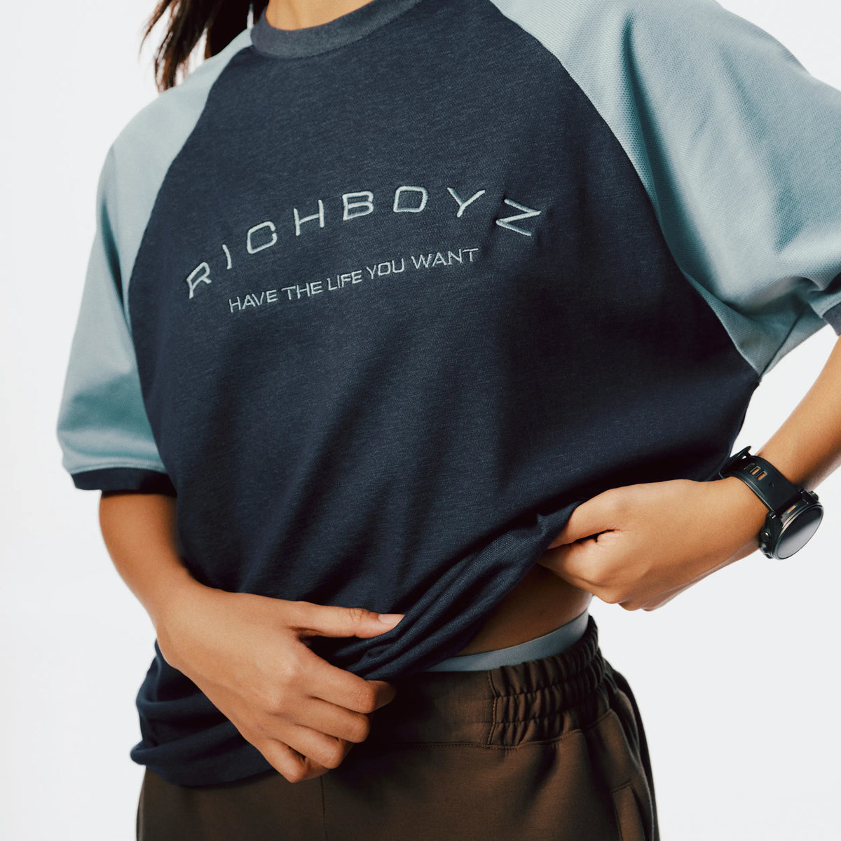 Close-up of Raglan Tee soft fabric texture and raglan sleeve seam detail in Denim Blue