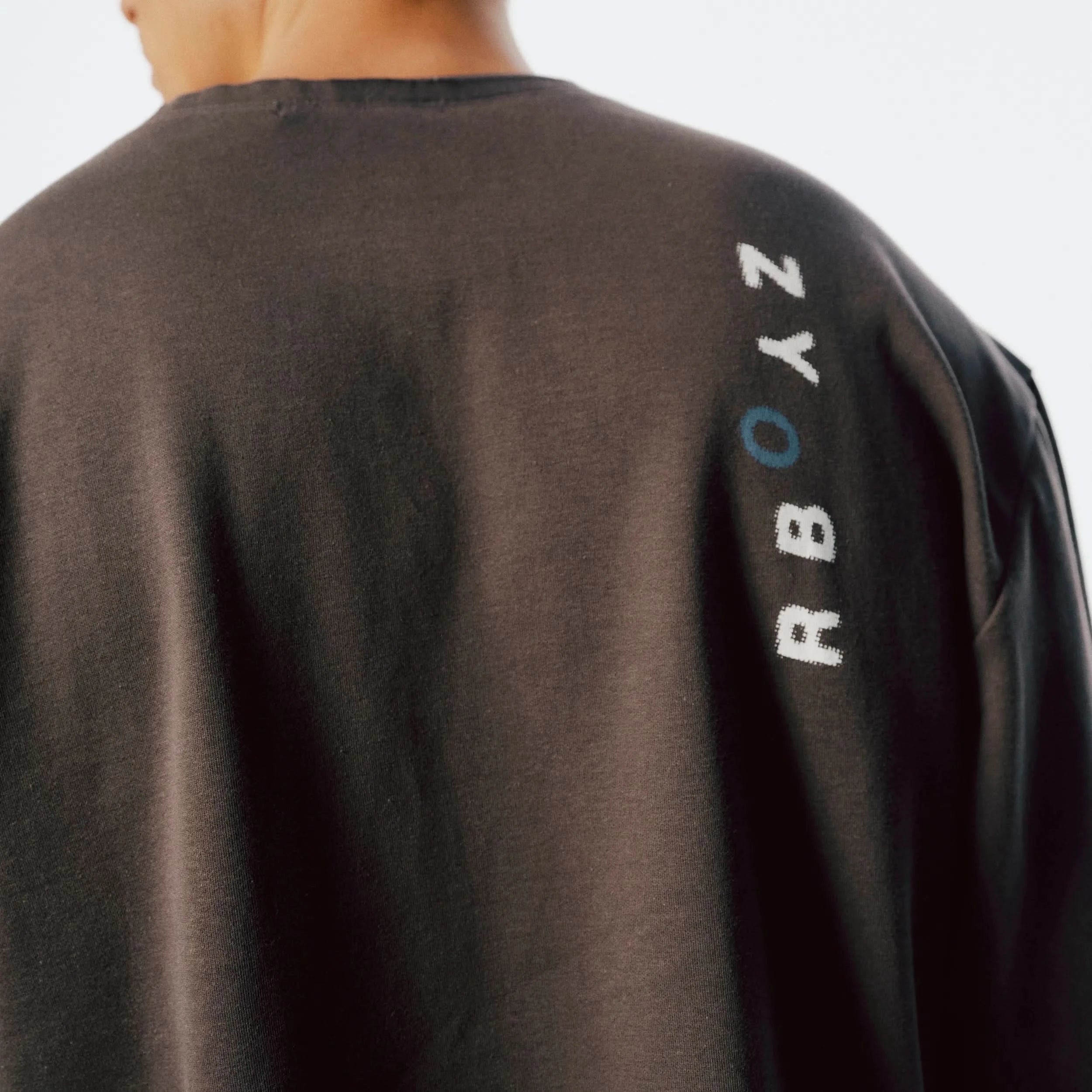 Close-up of Raw Edge Long Sleeve unfinished hem detail and soft fabric texture in Slate